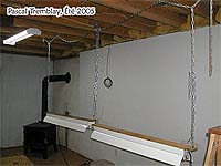 Starting seeds indoors with seedlings table with adjustable lamps on chains